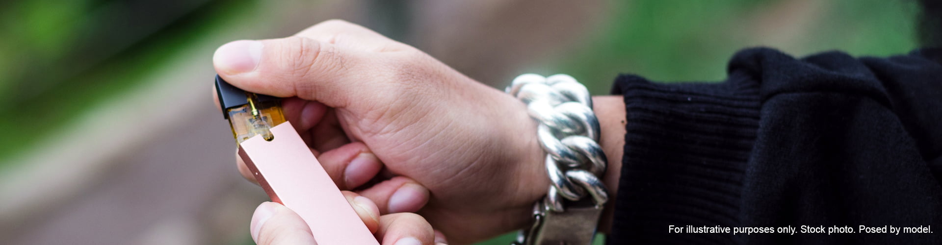 Hands holding leaking vape